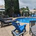 Riverboat Inn and Suites in Madison: outdoor pool with blue lounge chairs and umbrellas
