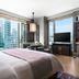The St. Regis Hong Kong guest room with city skyline views and large windows in Hong Kong