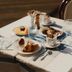 Breakfast table at Hotel Del Golfo in Finale Ligure with pastries, coffee, and juice by the sea