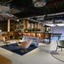 The Social Hub Barcelona Poblenou lounge with shelving, seating area, and open industrial ceiling in Barcelona