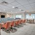 Holiday Inn Express & Suites Columbus Airport By IHG breakfast area with tables, orange chairs, and coffee station