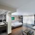 Schloss Reinach, Freiburg im Breisgau: spacious hotel room with sofa, bed, and floor-to-ceiling window