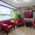 Red Roof Inn Kenly - I-95 lobby seating area with red chairs and stone accent wall