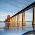 The Hawes Inn by Innkeeper's Collection, South Queensferry, with the Forth Bridge reflected in calm water.