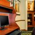 Residence Inn by Marriott Oklahoma City South work desk with monitor and shelving in Oklahoma City