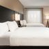 Residence Inn by Marriott Grand Rapids Downtown room with two beds, TV, and window with sheer curtains