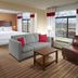 Four Points by Sheraton Nashville Airport room with king bed, sofa, desk and city-view windows