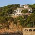 Hotel Sant Roc in Calella de Palafrugell perched on a cliff above the sea, with coastal views.