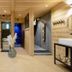 Hotel La Fontaine in Les Houches: cozy spa changing area with stone walls, bench, sink, and shower