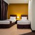 Orkid Inn Mahkota Cheras Kuala Lumpur twin room with two single beds and bedside lamp