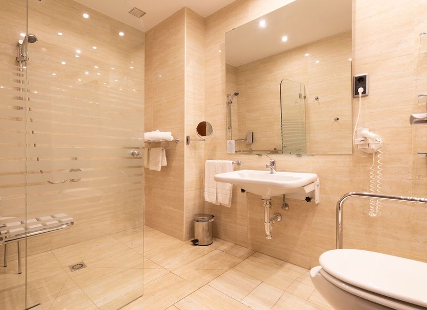 Hotel San Juan de los Reyes in Toledo bathroom with glass shower, sink, mirror, and toilet