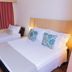 Hotel Lieto in Poços de Caldas guest room with one double bed and a single bed by the window