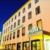 Hotel am Ludwigsplatz in Gießen, exterior at night with illuminated hotel sign and street view