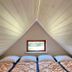 Grindsted Aktiv Camping attic room with four single beds and a small window in Grindsted