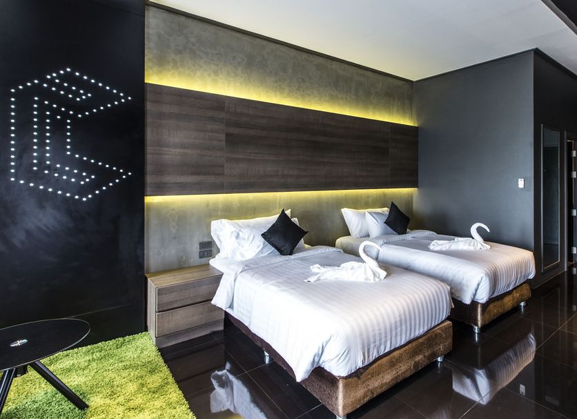 Cresco Hotel Buriram in Buri Ram twin guest room with lit headboard and swan towel figures