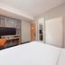 ibis Beijing Dongdaqiao hotel room with bed, desk, chair, mirror and wardrobe in Beijing