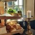 Älgbergets Bed & Breakfast in Stenungsund breakfast buffet with bread rolls, sliced bread, and a lit candle