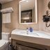 Bathroom at Hanting Hotel Hai'an Renmin West Road in Nantong with glass shower, sink and toilet