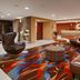 Best Western Plus Fresno Airport Hotel lobby with colorful carpet, modern seating, and front desk in Fresno