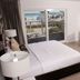 Lotus Boutique Inn & Suites in Ormond Beach guest room with balcony ocean view and desk