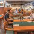 Wellness Hotel Step Prague restaurant with guests seated at wooden tables and buffet counter