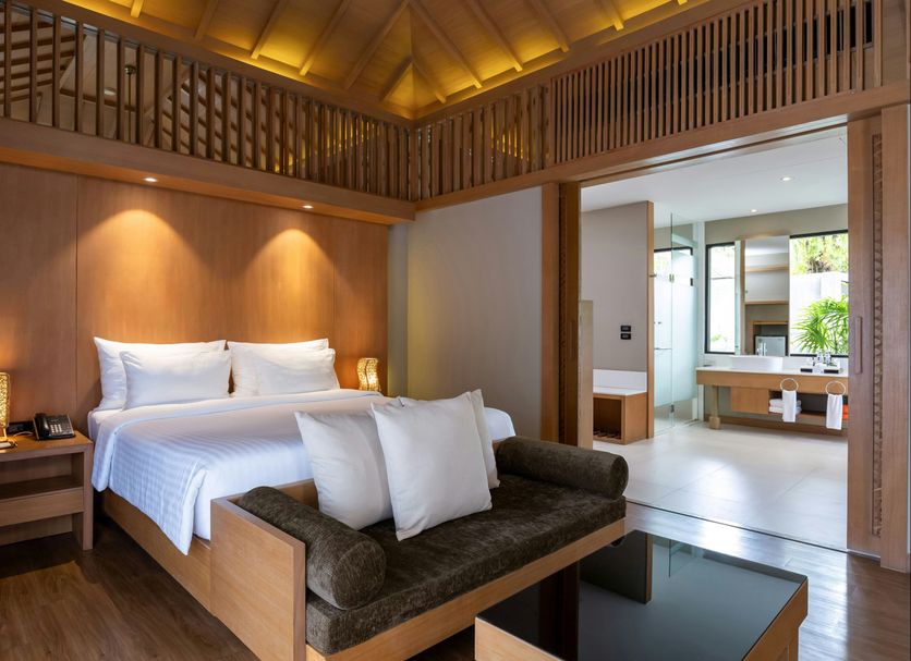 ananea Beyond Khaolak in Takua Pa: wooden suite with king bed, daybed and open bathroom vanity