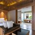 ananea Beyond Khaolak in Takua Pa: wooden suite with king bed, daybed and open bathroom vanity