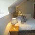 The Kings Head in Meifod bedroom with double bed, bedside lamps and sloped ceiling