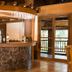 Canyon Woods Resort Club bar area in Laurel with stone-front counter and wood deck view