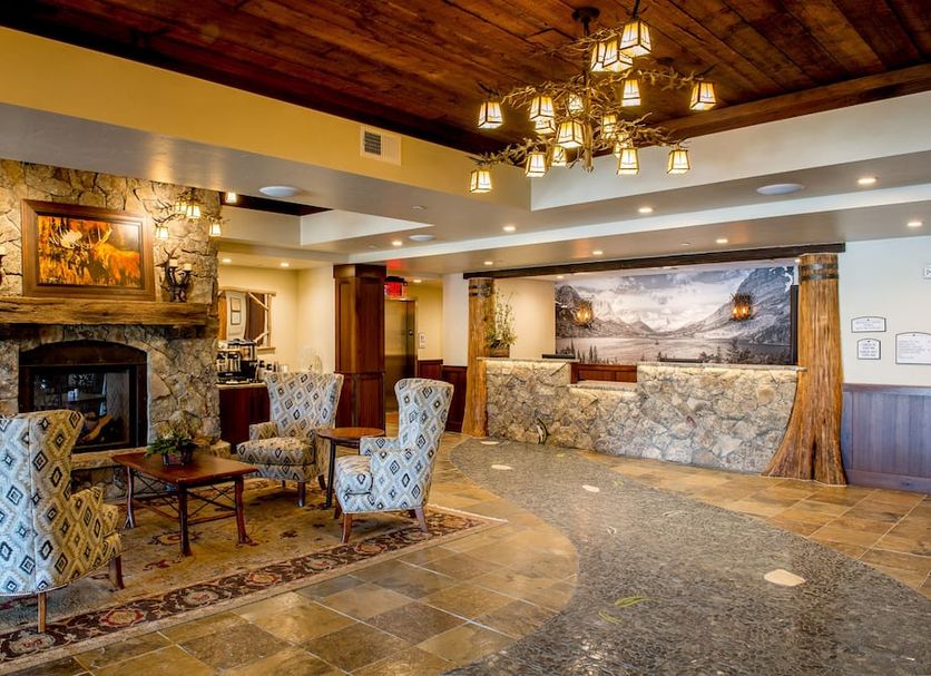 Cedar Creek Lodge And Conference Center in Columbia Falls lobby with stone fireplace and seating area