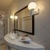 Hotel Maya del Mar bathroom in Playa del Carmen with vanity, mirror, and tiled shower