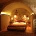 Anitya Cave House Ürgüp cave-style bedroom with arched stone ceiling and warm lighting