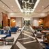 Sheraton The Walk, Dubai lobby with blue seating, patterned floor, and modern chandelier lighting
