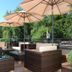 Gut Lauterbad Hotel in Freudenstadt terrace with wicker seating, umbrellas and forest view