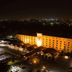 Golden Tulip Kumasi City in Kumasi, illuminated hotel exterior at night with city lights beyond
