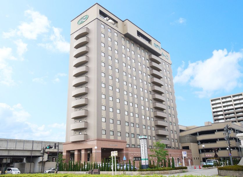 Hotel Route-Inn Kanazawa Ekimae high-rise exterior in Kanazawa with balconies and blue sky