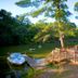 Lakeside Motel in Wisconsin Dells with lakeside dock, boat, and wooded waterfront view