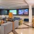 Holiday Inn Algarve Albufeira By IHG lounge with sofas, wall-mounted TVs and bright yellow accents in Albufeira