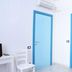 Camere D'Aragona, Otranto: bright room with blue-trimmed doors, chair, desk and mini fridge