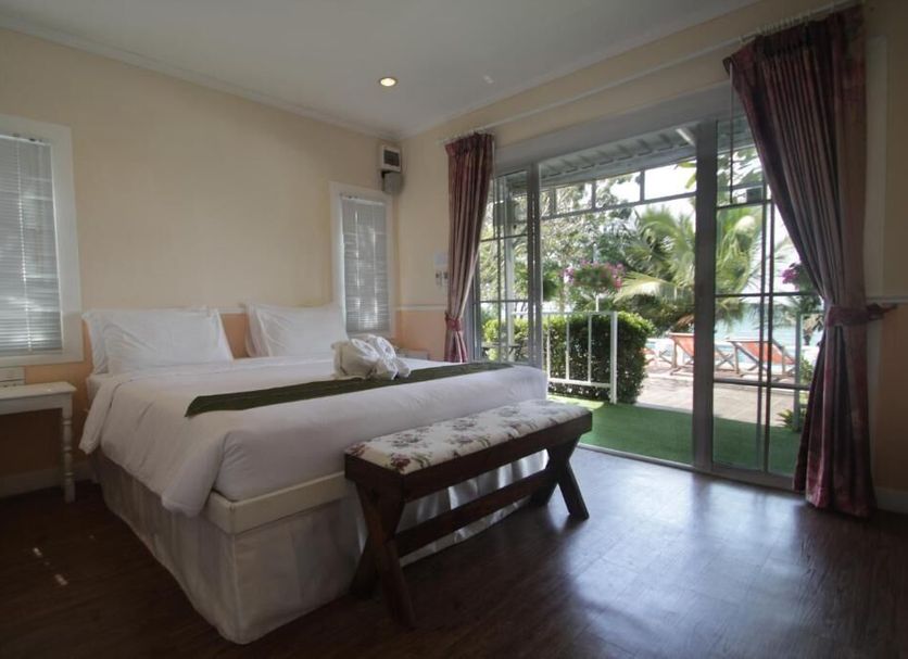 Pattaya Paradise Beach Resort room with king bed and sliding glass doors to balcony or patio in Pattaya