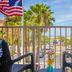 Treasure Island Hotel and Marina balcony view with palm trees, marina, and ocean in Treasure Island