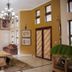 Zawadi House Arusha lobby with chandelier, framed art, seating area and patterned double doors