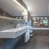 Auberge de La Maison, Courmayeur bathroom with double vanity, soaking tub by window, and bidet