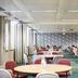 Kents Hill Park Training & Conference Centre in Milton Keynes conference room with round tables and red chairs