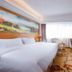 Jinghu Hotel Shenzhen guest room with twin beds, desk, chairs, window and city view