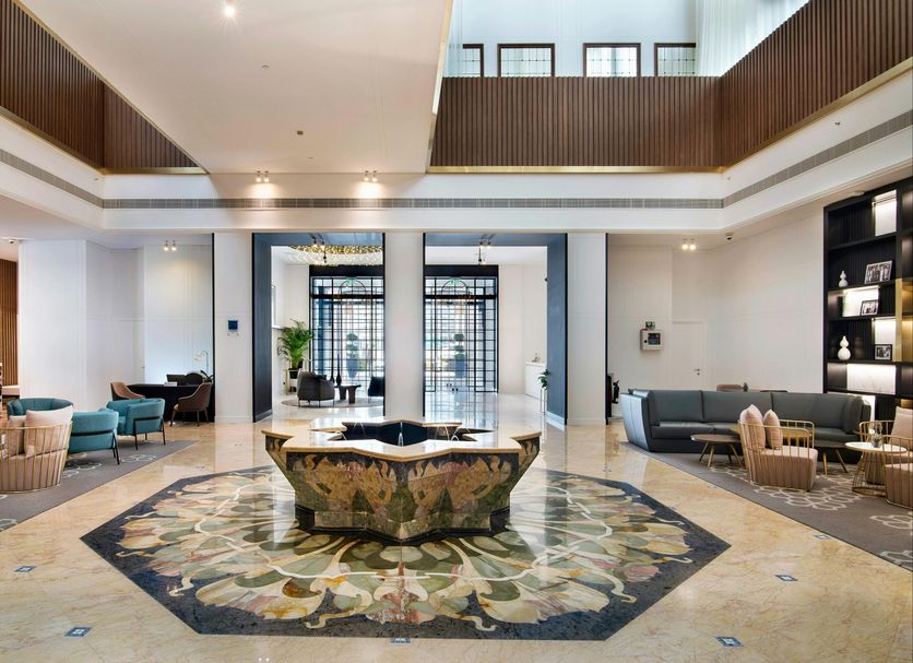 Le Méridien Abu Dhabi Resort lobby with mosaic floor centerpiece, seating area and double-height atrium in Abu Dhabi