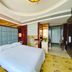 Huangtai International Hotel in Jinan guest room with king bed, modern headboard, and marble bath area