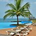 Pestana São Tomé infinity pool with palm tree, lounge chairs and ocean view in São Tomé