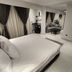 Helio Cairo Hotel in Cairo, guest room with king bed, sitting area and dark curtains
