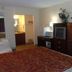 Executive Inn Rocky Top guest room with king bed, dresser, mirror, and lamp